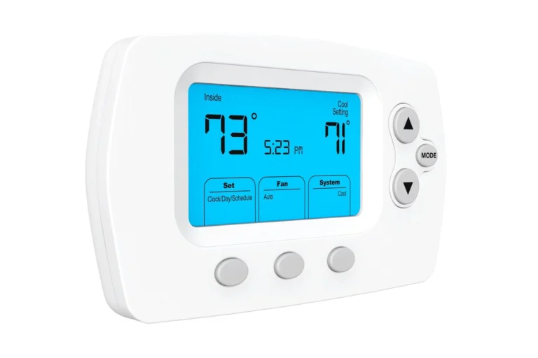 Digital thermostat with a blue backlit screen displaying an inside temperature of 79°F, a cool setting of 71°F, and the time 5:23 PM. Buttons for fan, system, and mode are visible.